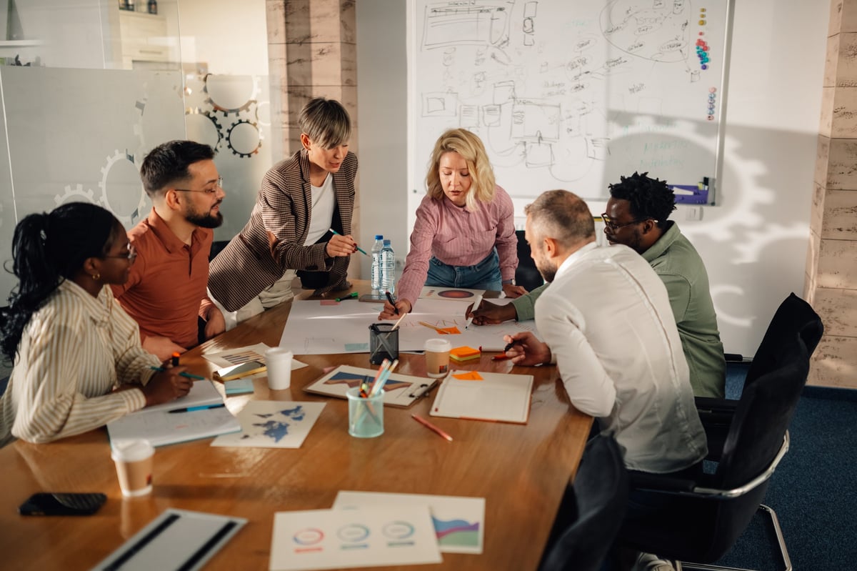 Diverse team of marketing professionals working together on a project in a modern office