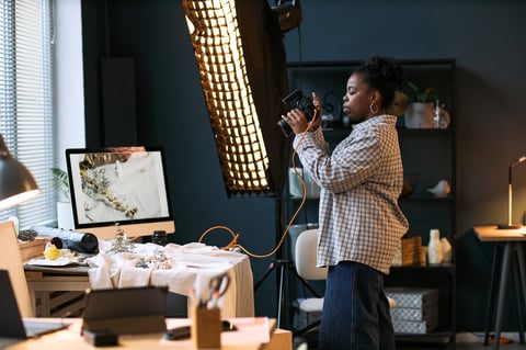 Photographer capturing a creative tabletop arrangement in a studio