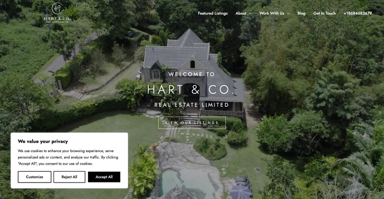 Aerial view of luxury manor house surrounded by green grounds with Hart & Co Real Estate Limited welcome overlay